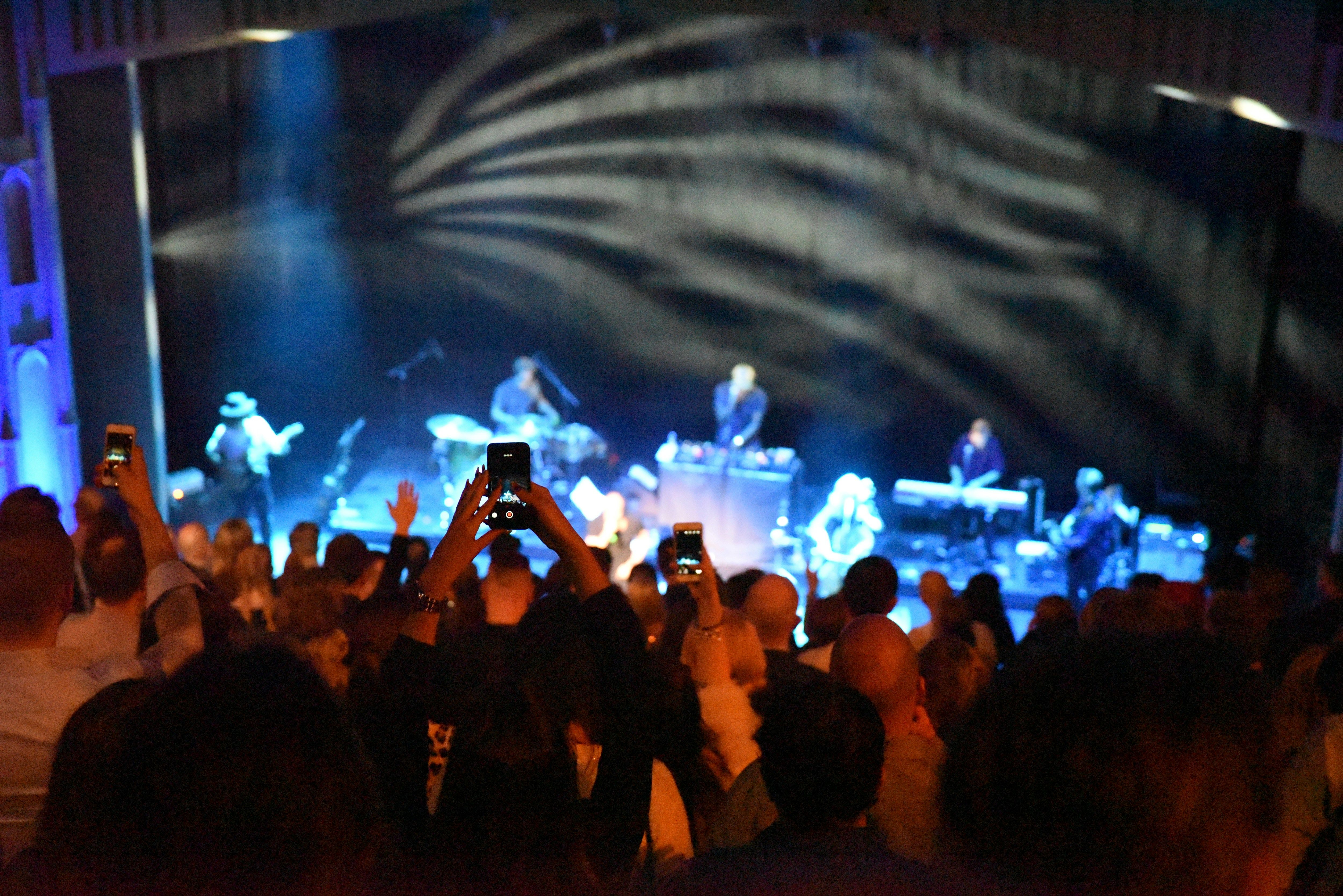 a group of people taking pictures of a concert